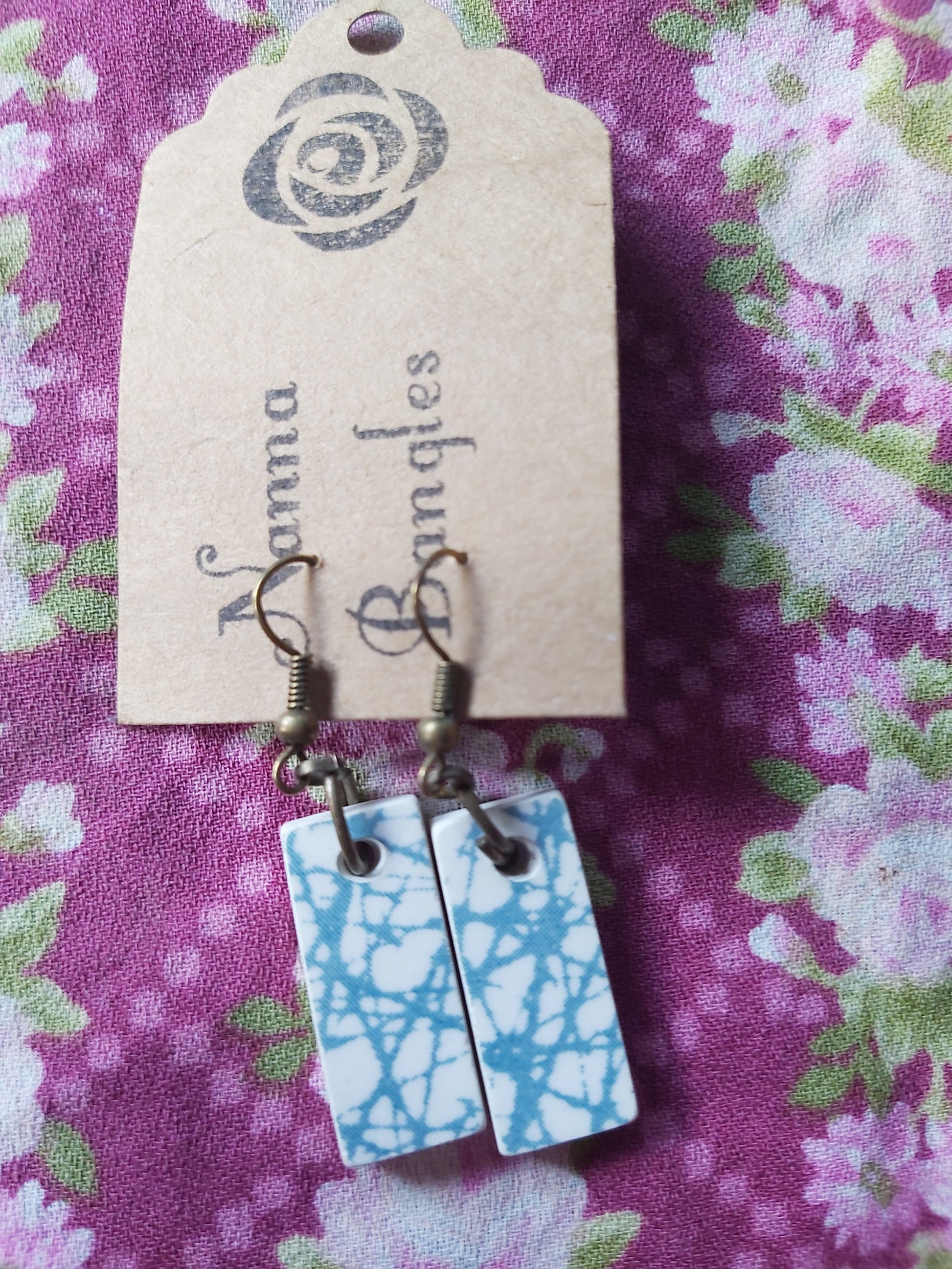 NEW Upcycled Ceramic Earrings - Crown Lynn Moonglow Blue on Nanna Bangles-branded card, against purple floral backdrop.