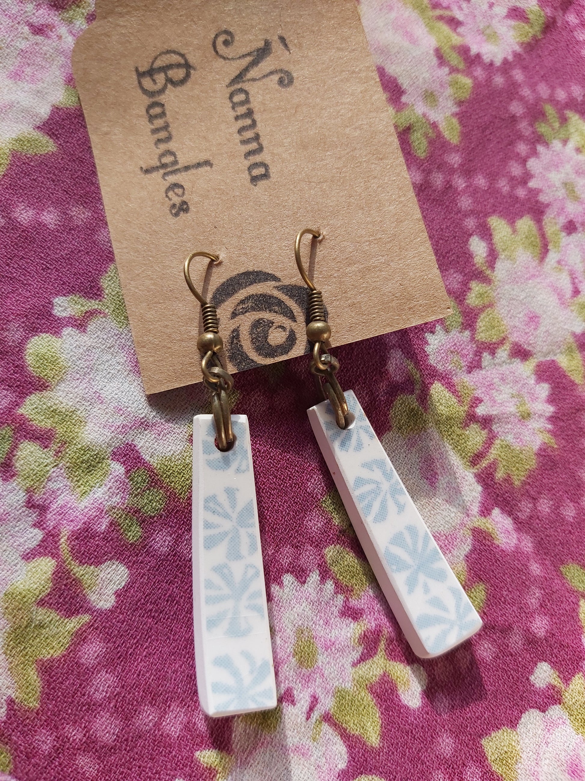 NEW Upcycled Ceramic Earrings - Crown Lynn Blue Pacific #2 on Nanna Bangles-branded card, against purple floral backdrop.