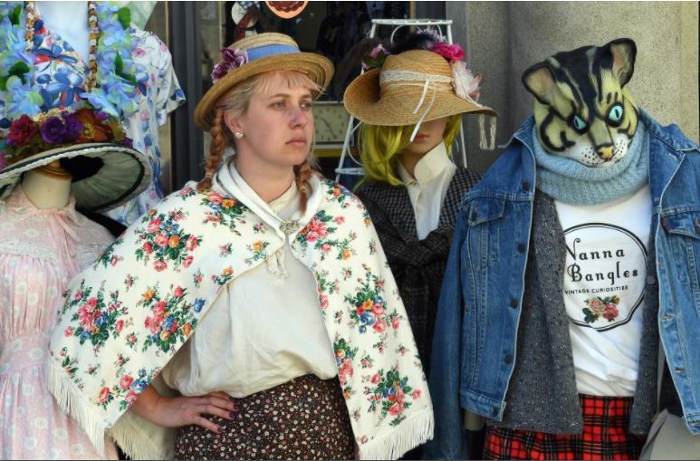 Photograph from the Otago Daily Times newspaper of Livvi posing in a vintage outfit in the Nanna Bangles shop in the Victorian Precinct of Oamaru, New Zealand.